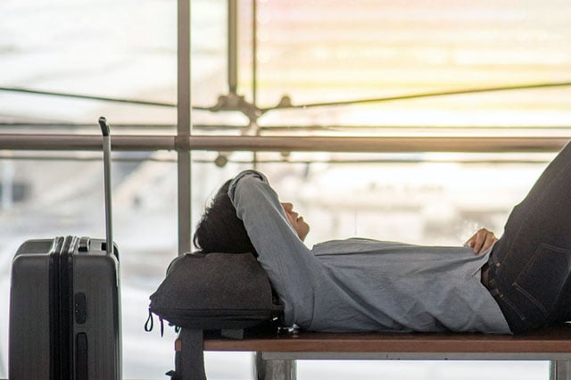 A little boy watching an airplane in an airport