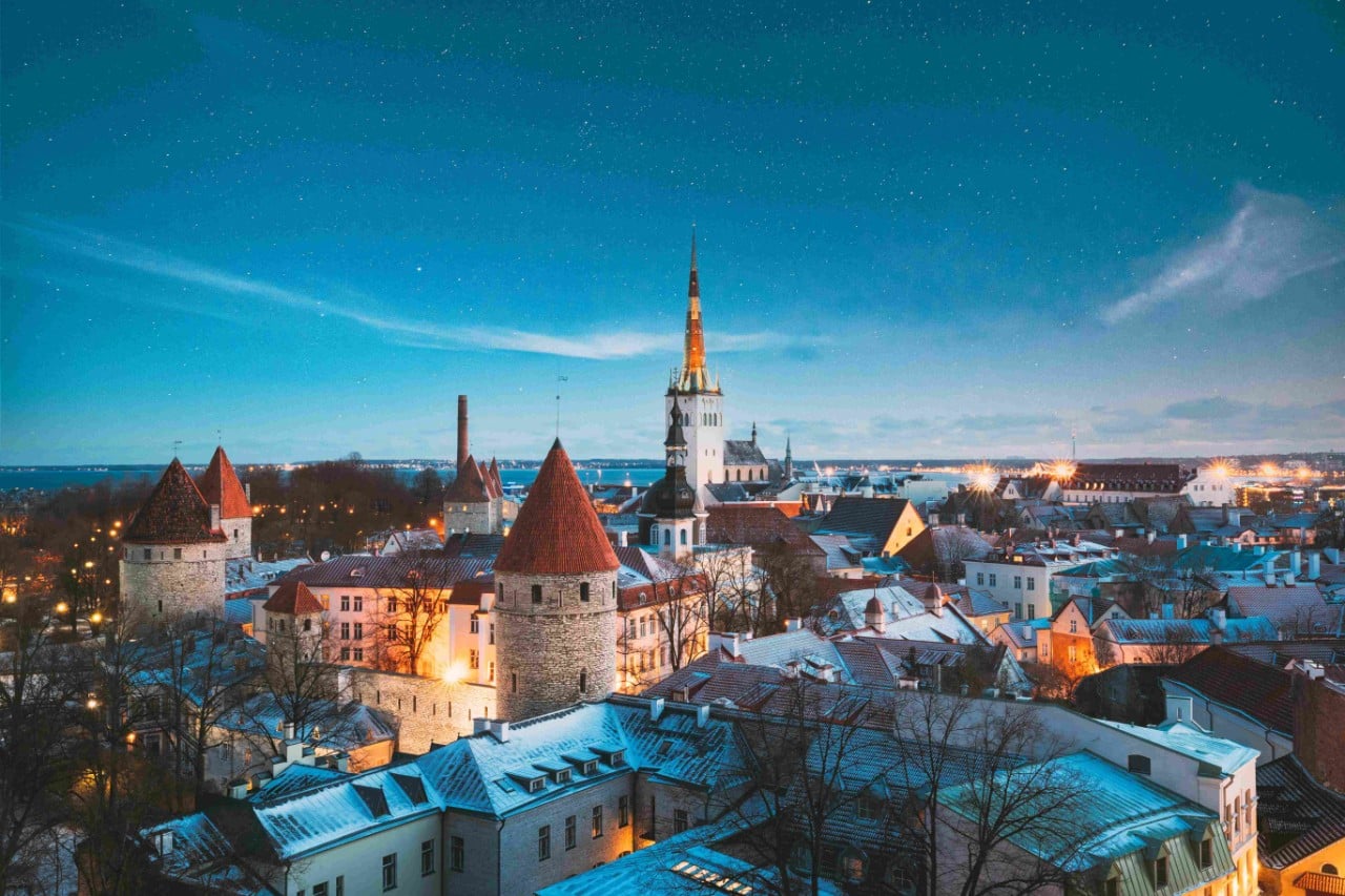 Tallinn, Estonia. Night Starry Sky Above Old Castle Walls Architecture